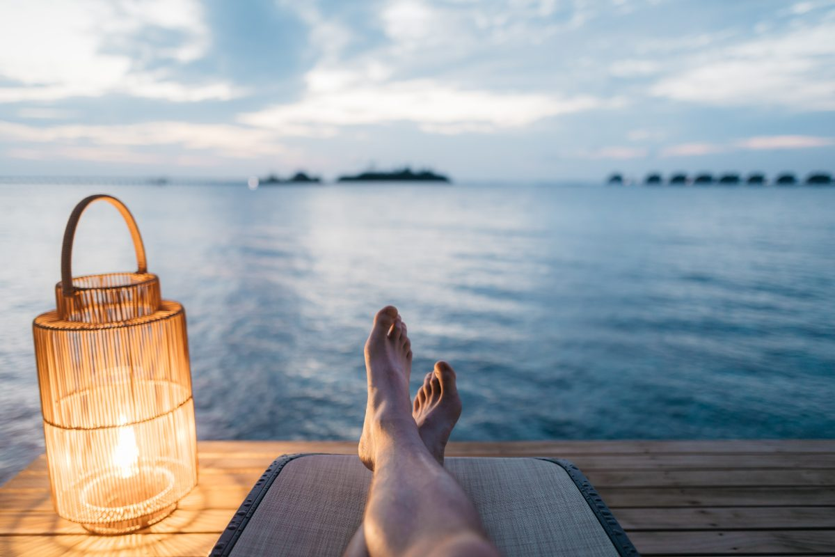 Traveler relaxing by the water before the all-inclusive package guide section